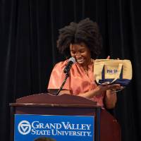 person at podium showing lunch bag